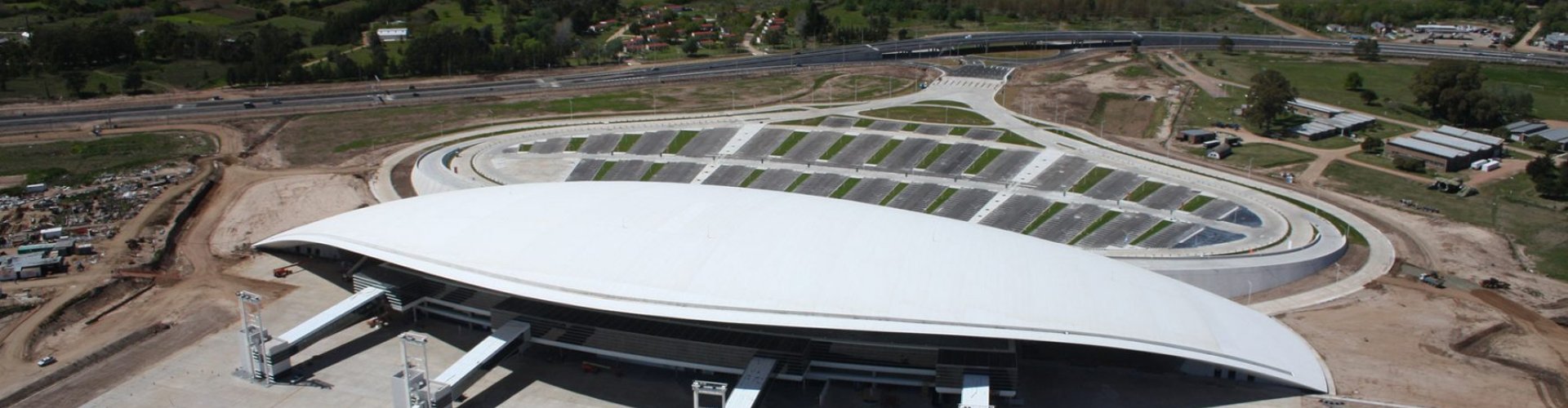Sunset view of Carrasco Intl Airport terminal with family departing