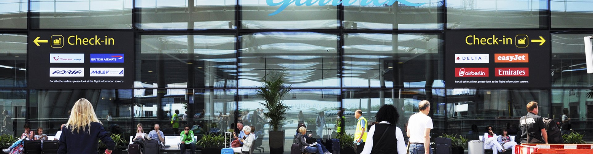Sunset view of Gatwick Airport terminal with families