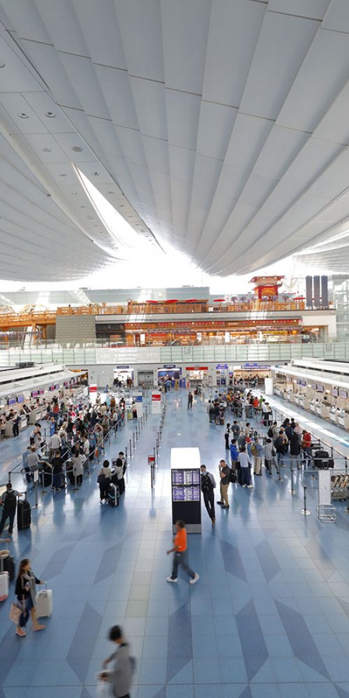Parent and toddler relaxing at Tokyo Haneda Airport playground
