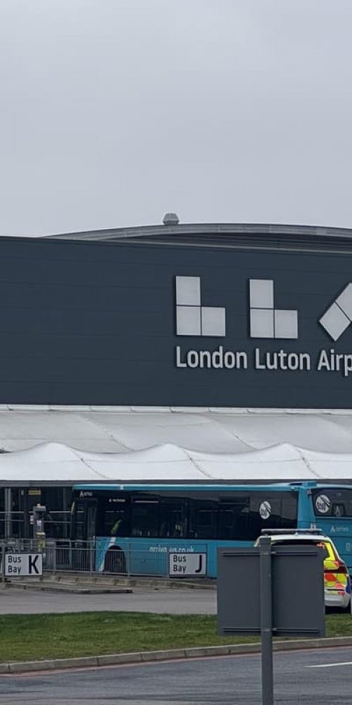 Parent and child resting at Luton Airport, UK Airport